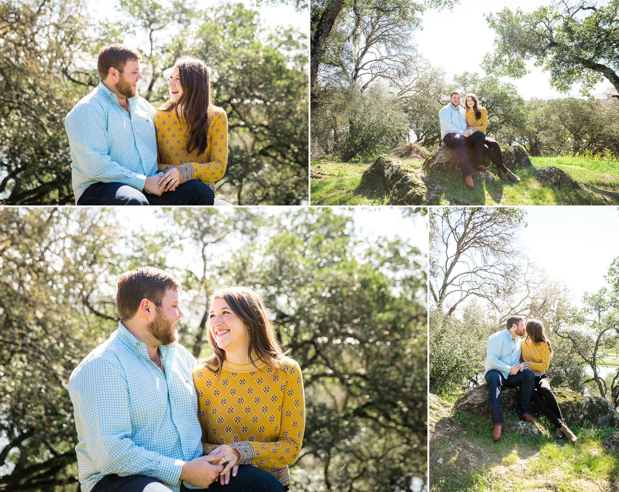 a couple sits on a rock looking lovingly at each other