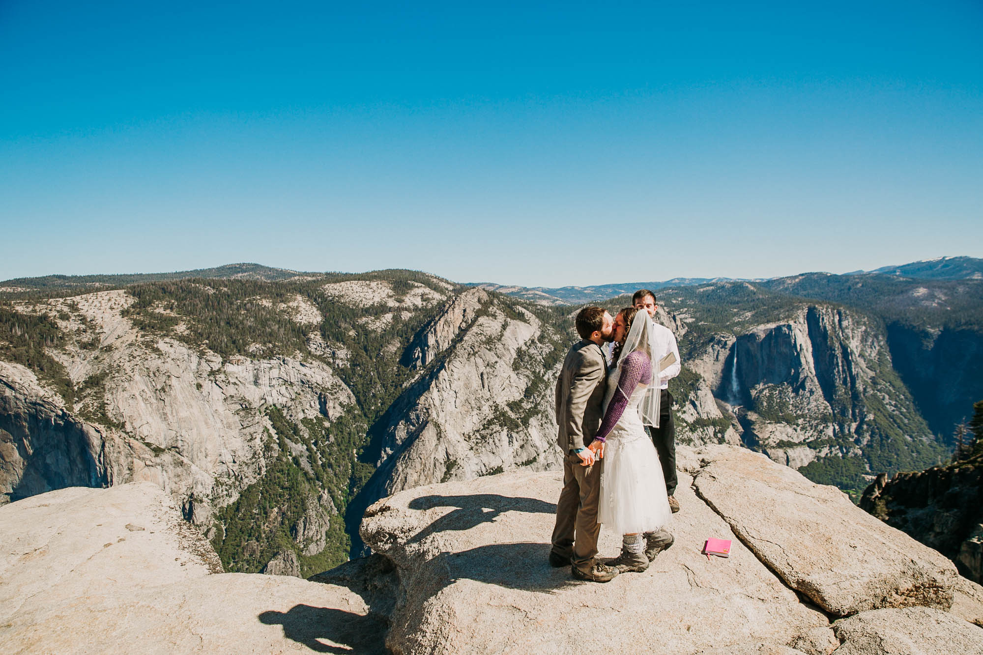 newlyweds kiss on Taft Point, Yosemite Valley