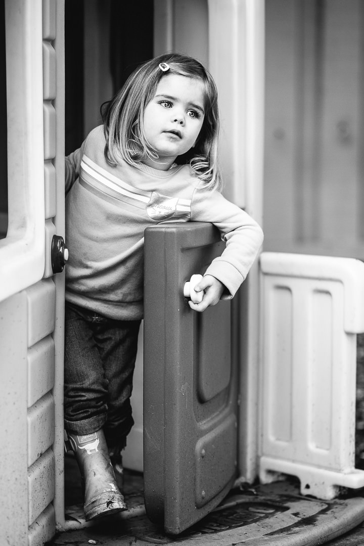 little girl standing at a door